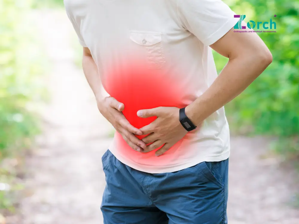 Man experiencing stomach discomfort outdoors, illustrating common causes of abdominal pain and the need for effective abdominal pain treatment