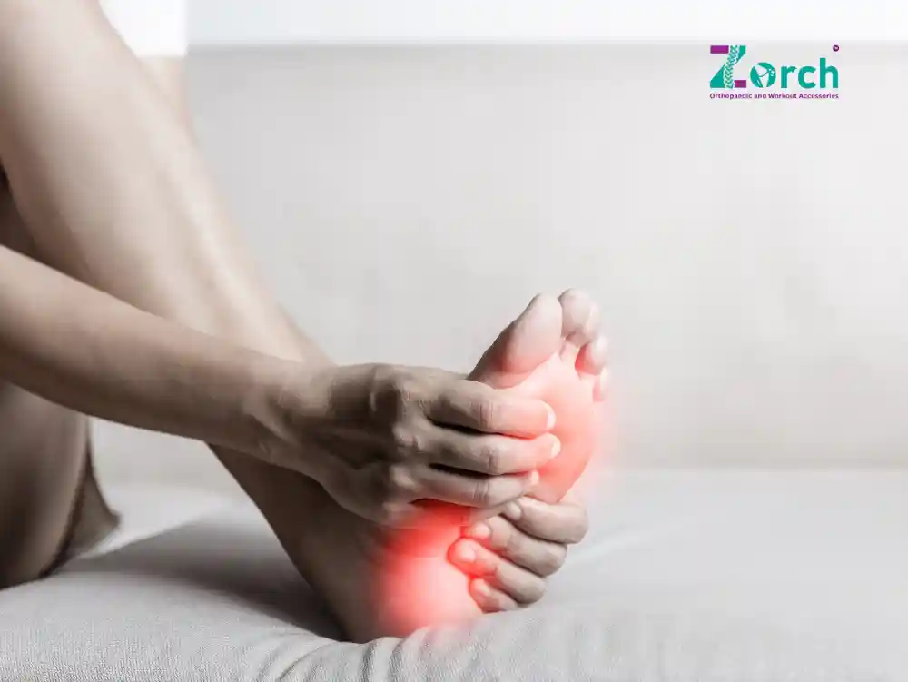 A person holding the bottom of their foot with visible pain highlighted, showing how to relieve pain on bottom of foot naturally.